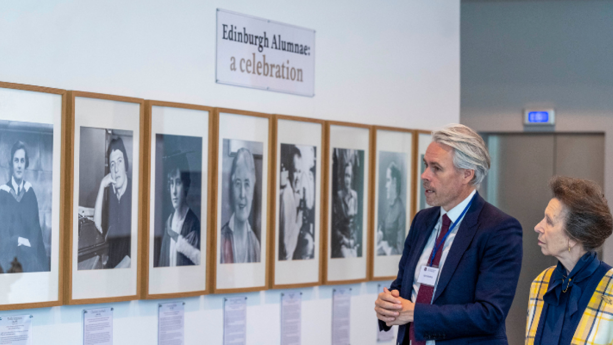 The Chancellor views portraits of female alumnus with Professor Iain Gordon