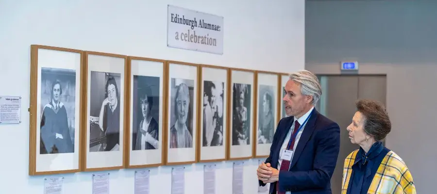 The Chancellor views portraits of female alumnus with Professor Iain Gordon