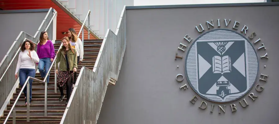 A campus staircase next to the University logo