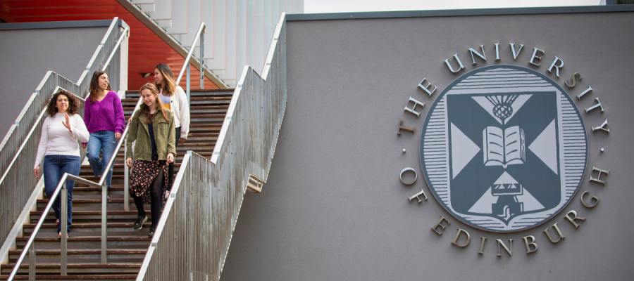 A campus staircase next to the University logo