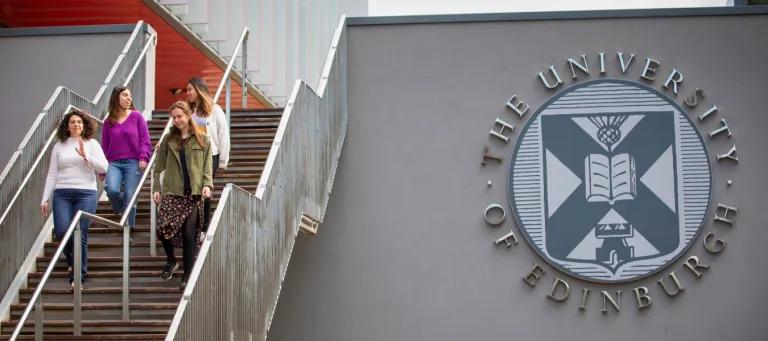 A campus staircase next to the University logo